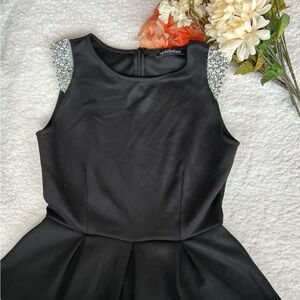 Sleeveless shoulder sequin black peplum top size Large